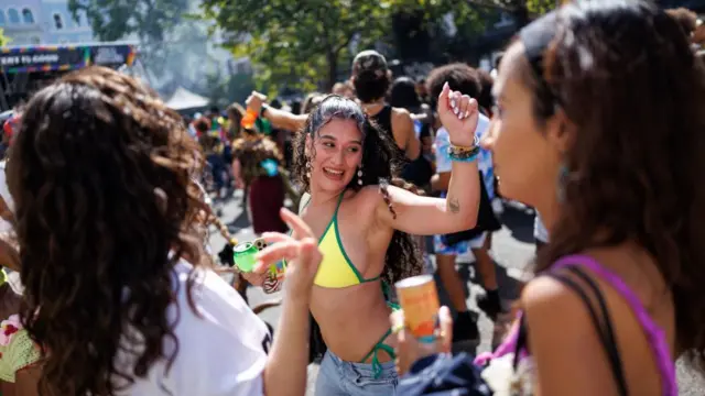 Carnival revellers dance to the music during the Notting Hill Carnival