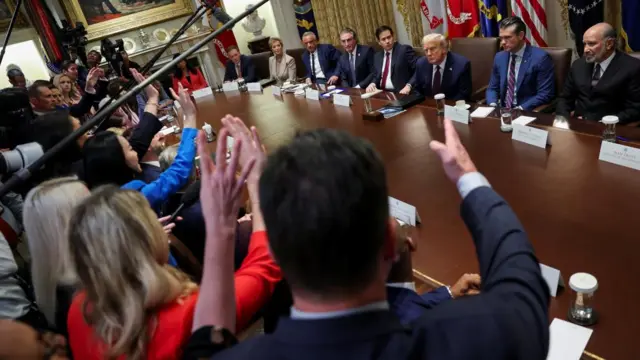 Reporters ask questions at a White House cabinet meeting