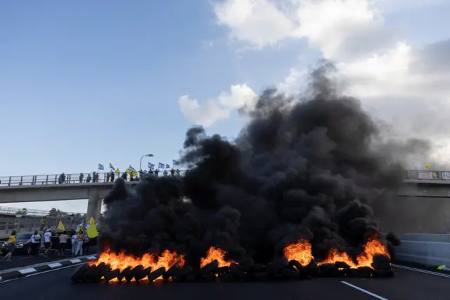 Protesters burned tires and blocked traffic on a main road in Israel