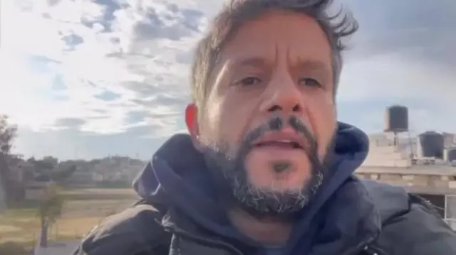 A selfie image of Hussam Al-Masri, apparently mid speech