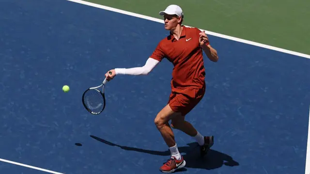 Jannik Sinner plays a forehand return