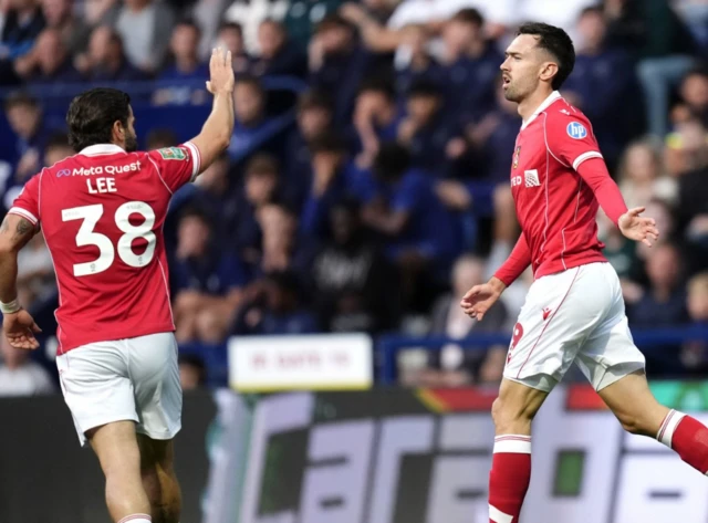 Wrexham's Ryan Hardie (right) celebrates scoring their side's first goal of the game