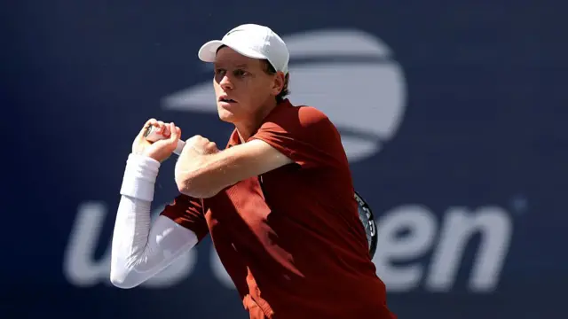 Jannik Sinner plays a backhand winner