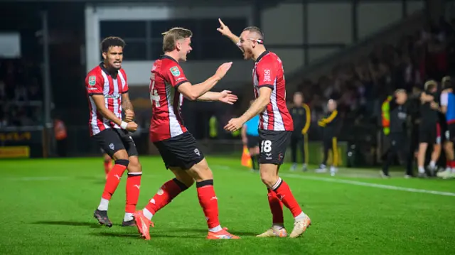 en House of Lincoln City, right, celebrates