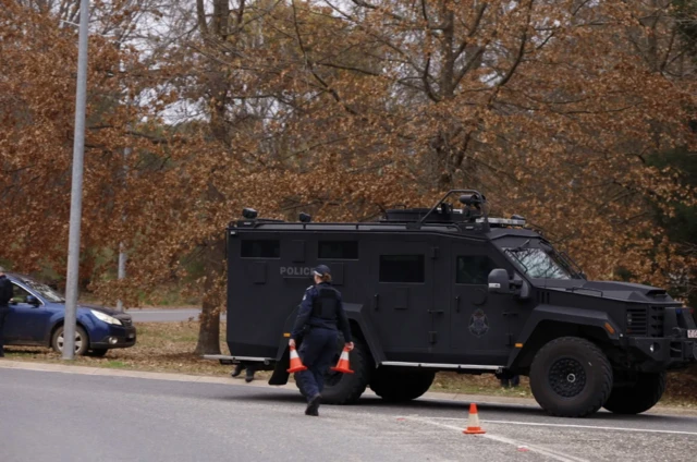 An armoured police vehicle on a road at the scene