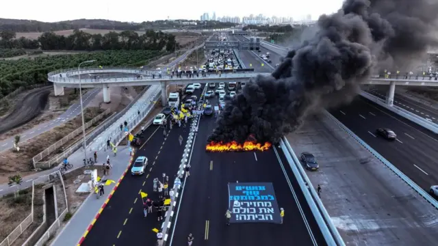 A drone view of protesters blocking a main road during a demonstration demanding the immediate end of the war and the release of all hostages who were kidnapped during the deadly October 7, 2023, attack on Israel by Hamas, in Yakum near Tel Aviv, Israel August 26, 2025.