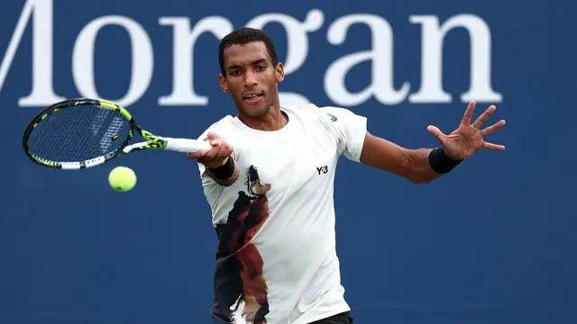 Felix Auger-Aliassime of Canada hits a forehand return