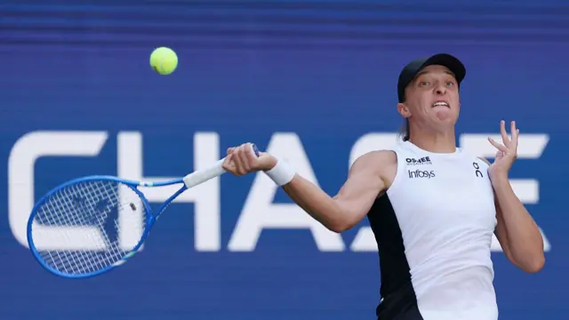 Iga Swiatek of Poland hits a forehand return