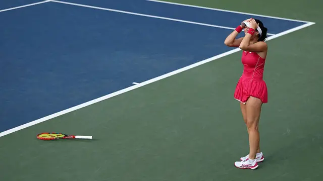 Eva Lys celebrates as she drops her racquet and puts her hands on her head