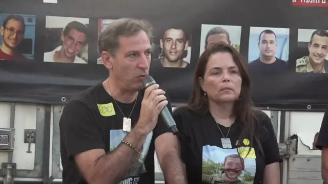 Ruby Chen holds a microphone as he speaks during a news conference in Tel Aviv