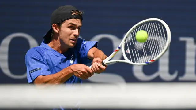 USA's Zachary Svajda plays a return to Serbia's Novak Djokovic