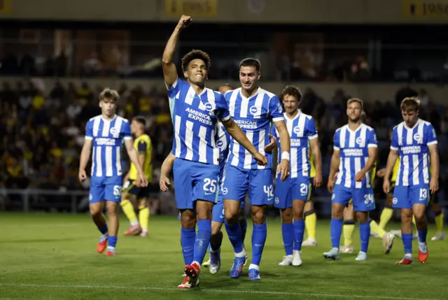 Brighton & Hove Albion's Diego Gomez celebrates scoring their third goal with teammates
