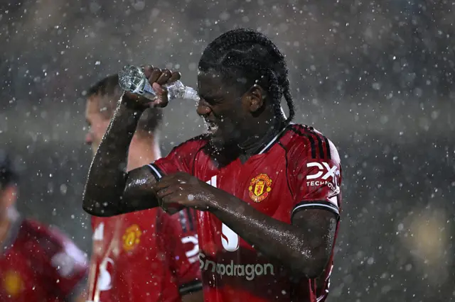 Ayden Heaven of Manchester United pours water into his eye during the Carabao Cup Second Round match between Grimsby Town and Manchester United at Blundell Park on August 27, 2025 in Grimsby, England.