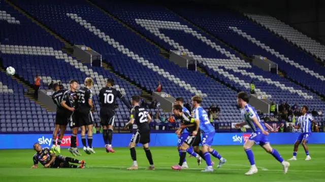 Jamal Lowe takes a free-kick for Sheffield Wednesday during their EFL Cup win over Leeds in front of an empty stand