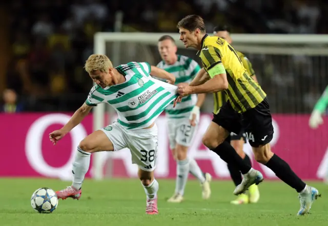 Kairat's Alyaksandr Martynovich in action with Celtic's Daizen Maeda