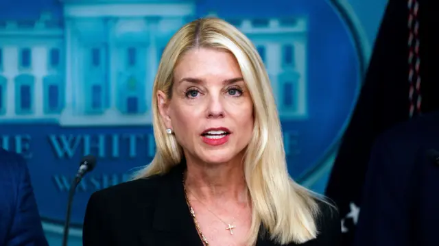 Pam Bondi in a black suit in the press room of the White House
