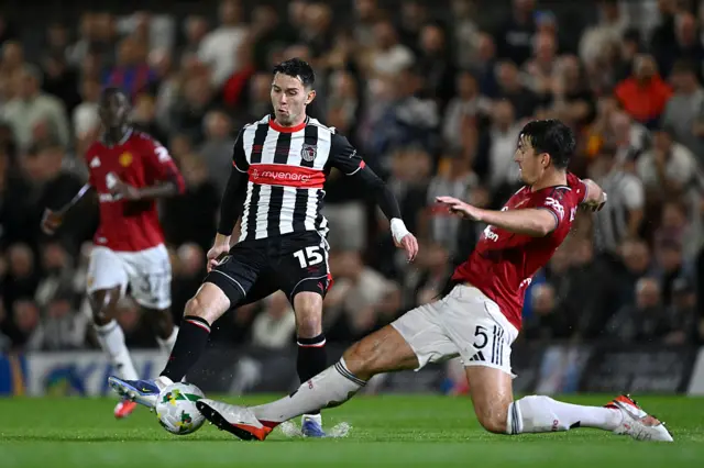 Geza David Turi is challenged by Harry Maguire