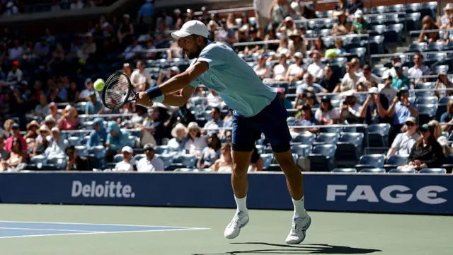 Novak Djokovic hits a backhand