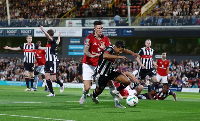 Manchester United's Benjamin Sesko in action with Grimsby Town's Evan Khouri