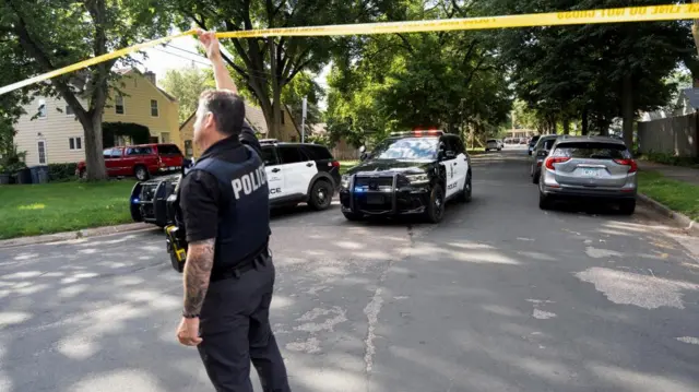 A police vehicle leaves a security perimeter