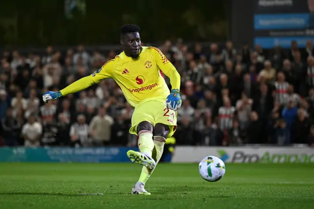 Andre Onana of Manchester United scores the team's eleventh penalty in the penalty shoot out during the Carabao Cup Second Round match between Grimsby Town and Manchester United at Blundell Park on August 27, 2025 in Grimsby, England.