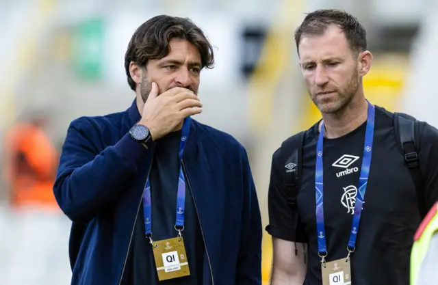 Rangers head coach Russell Martin in conversation with coach Mike Williamson