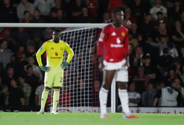 Manchester United's Andre Onana looks dejected after Grimsby Town's Tyrell Warren scores their second goal