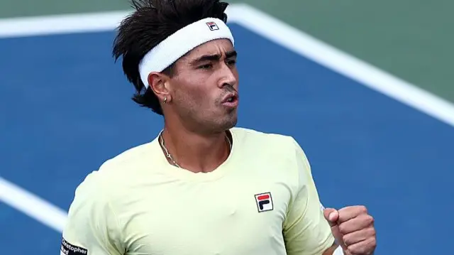 Francisco Comesana reacts after taking a break of serve