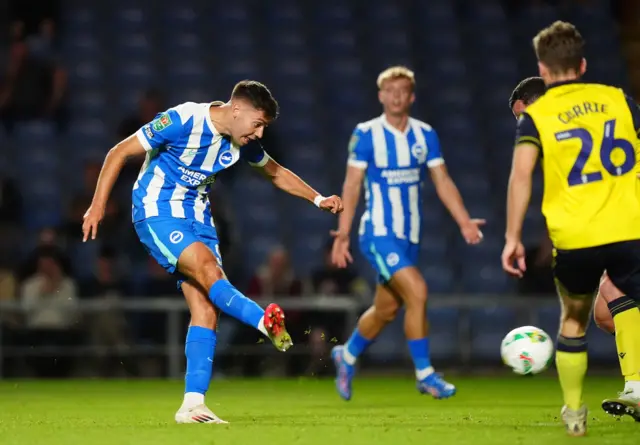 Brighton and Hove Albion's Stefanos Tzimas (left) scores his sides fifth goal