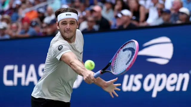 Taylor Fritz stretches for a backhand shot