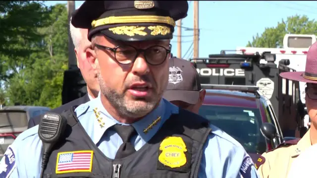 Police chief in hat and black vest