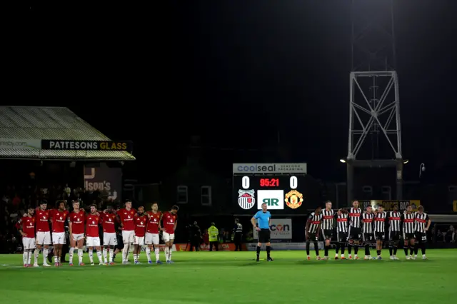Manchester United’s and Grimsby Town’s players during the penalty shoot out