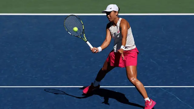Janice Tjen hits a volley