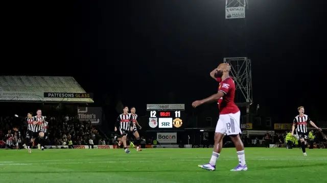Manchester United's Bryan Mbeumo with a hand on his head after missing the decisive penalty against Grimsby