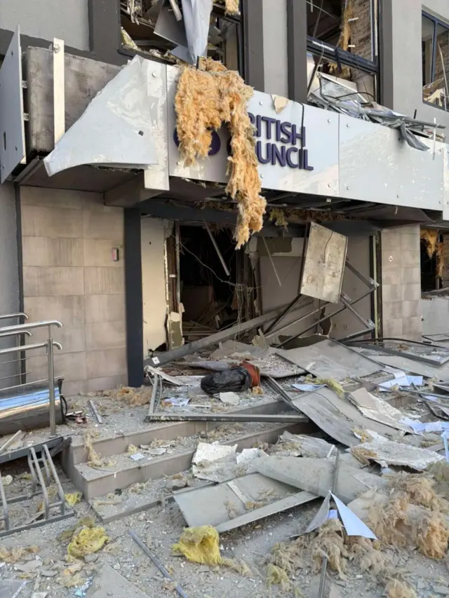 Outside view of the British Council office in Kyiv, piles of debris and insulation strewn on the ground in front of the main entrance
