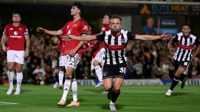 Charles Vernam celebrates scoring for Grimsby Town against Manchester United