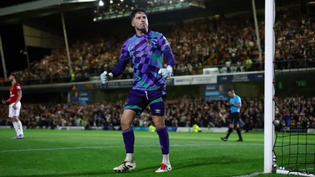 Christy Pym celebrates saving Matheus Cunha's penalty