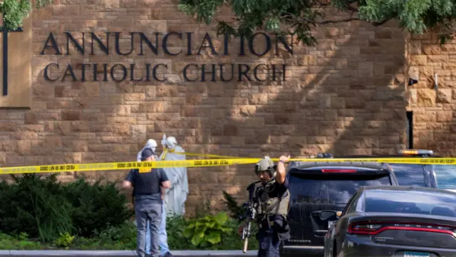 Annunciation Church with an armed officer and police tape in the foreground