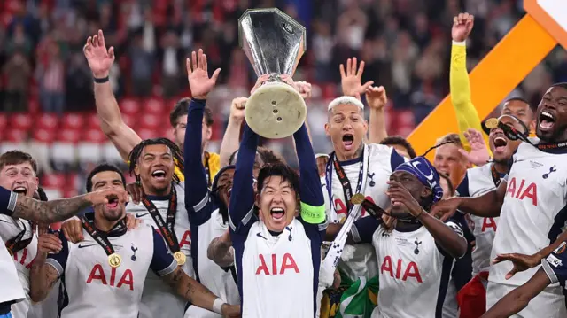Tottenham players celebrate with Europa League trophy