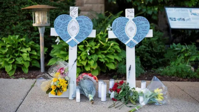 A memorial honouring shooting victims sits outside the Annunciation Church