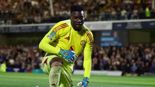 Andre Onana on his knees during Manchester United's EFL Cup defeat by Grimsby
