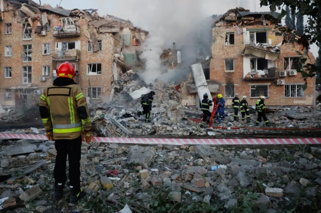 Rescuers work at the site of an apartment building which was hit by Russian missile and drone strikes, amid Russia's attack on Ukraine, in Kyiv, 28 August 2025.