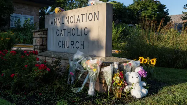 Flowers and a stuffed animal sit outside the Annunciation Church, which is a home to an elementary school and was the scene of a shooting the day before, in Minneapolis, Minnesota, U.S. August 28, 2025.