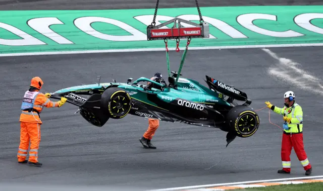 Lance Stroll's damaged Aston Martin is lifted away