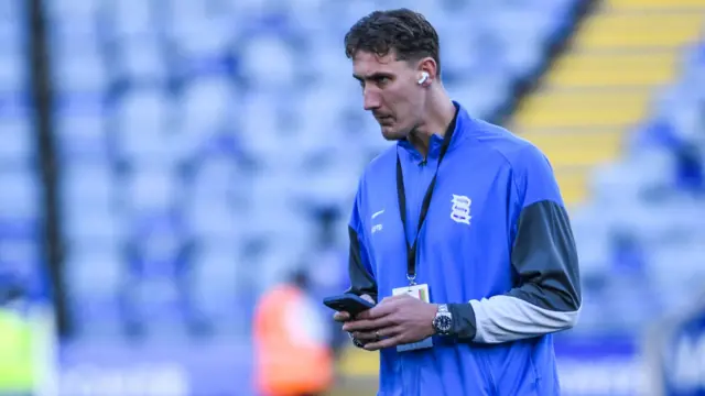 Birmingham's Phil Neumann, holding his phone as he arrives at the King Power Stadium