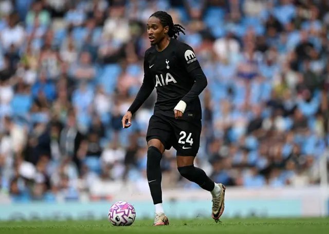 Djed Spence of Tottenham Hotspur runs with the ball during the Premier League match between Manchester City and Tottenham Hotspur at Etihad Stadium on August 23, 2025 in Manchester, England.