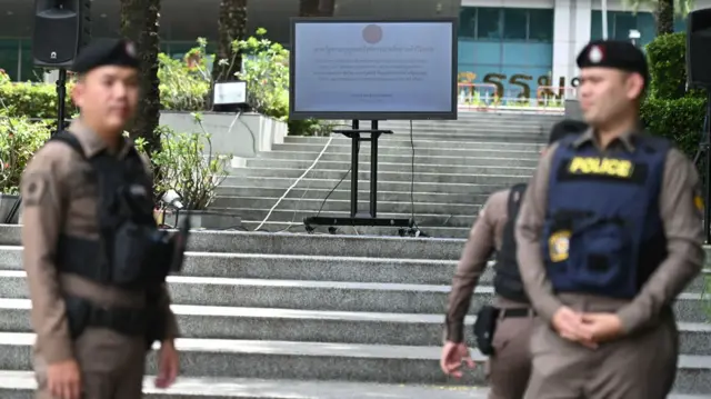 Security guards standing in front of a flight of steps