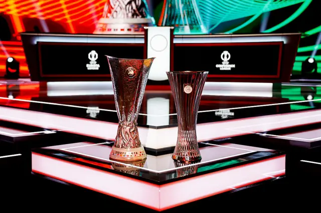 The UEFA Europa League trophy and the UEFA Conference League trophy are seen on the stage ahead of the UEFA Conference League 2025/26 League Phase Draw at Grimaldi Forum on August 27, 2025 in Monaco, Monaco.