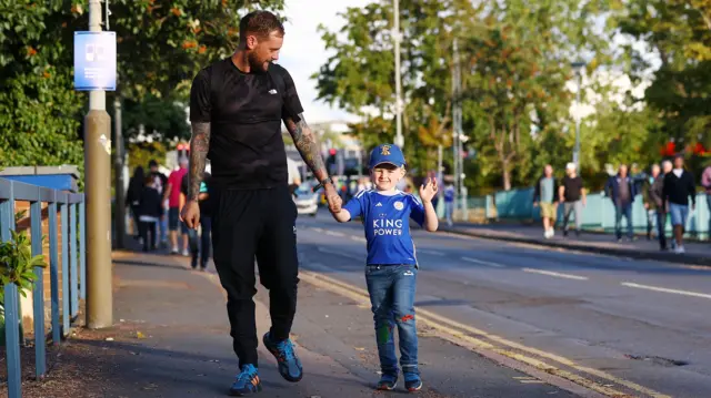 A young Leicester fan arrives at the King Power Stadium