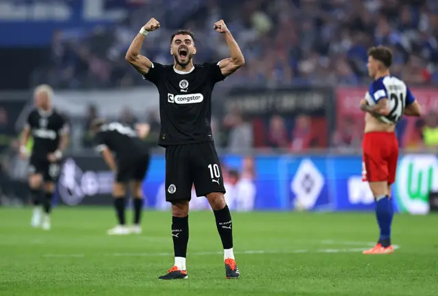 Danel Sinani of St Pauli celebrates after the team's victory in the Bundesliga match between Hamburger SV and FC St. Pauli